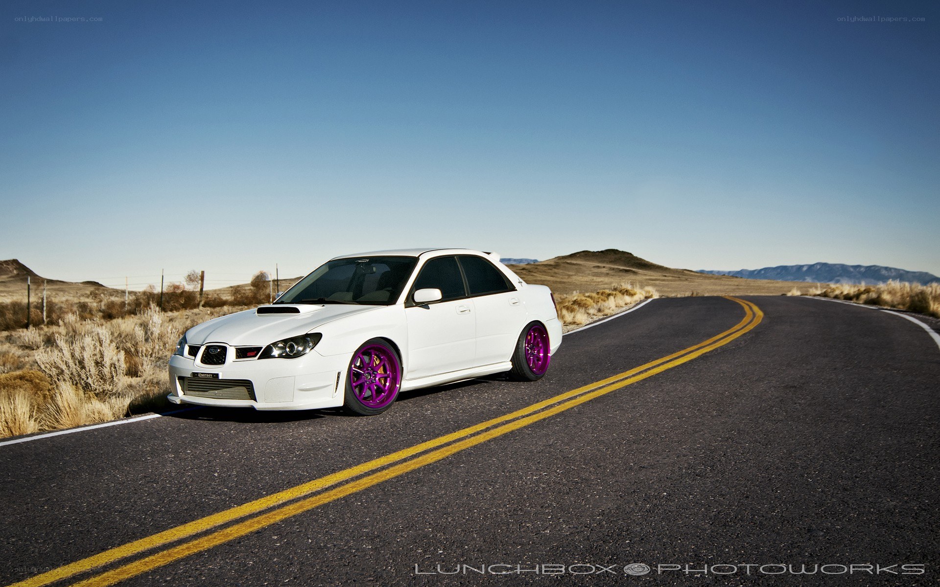 white car on desert road