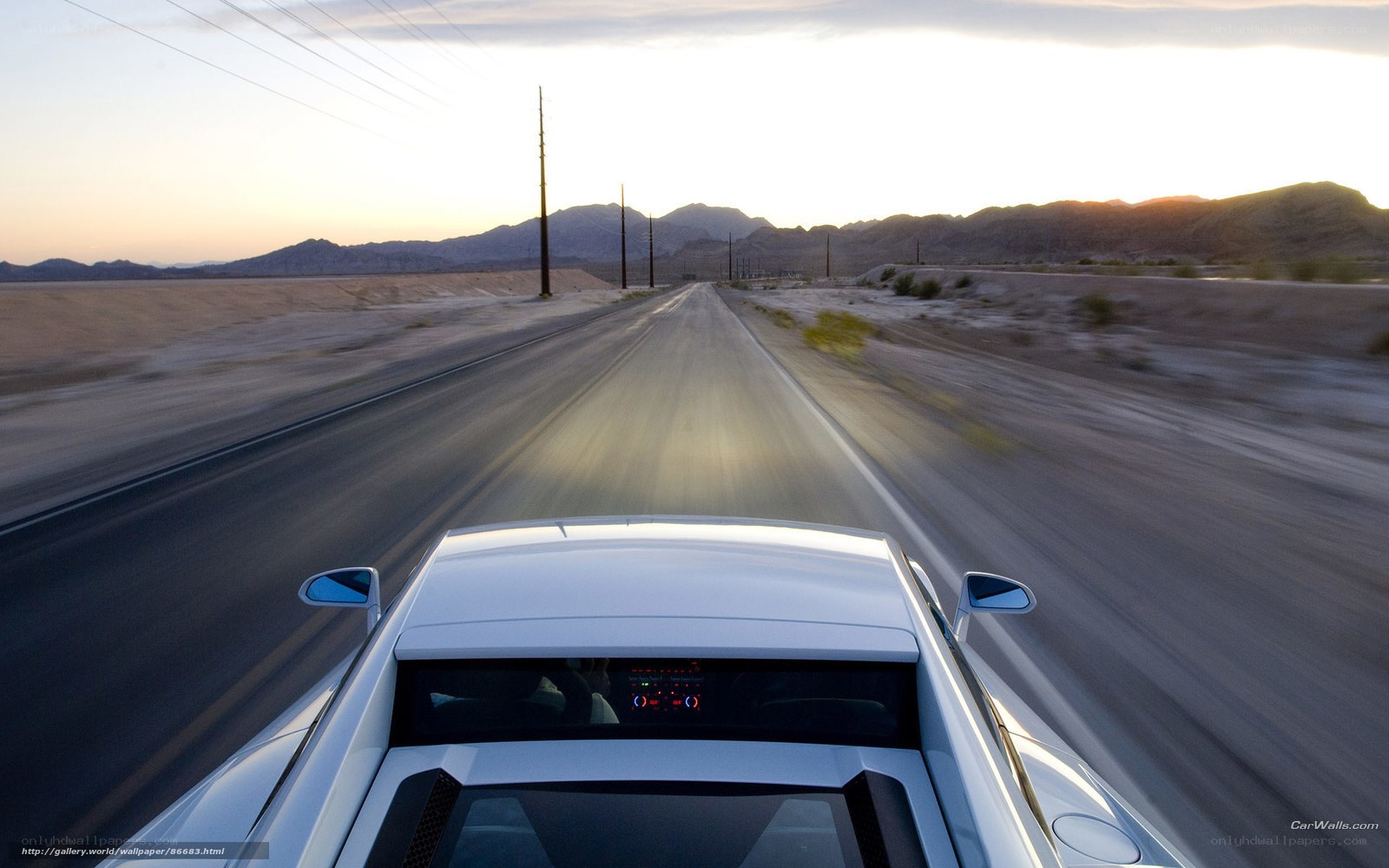 White car on desert road
