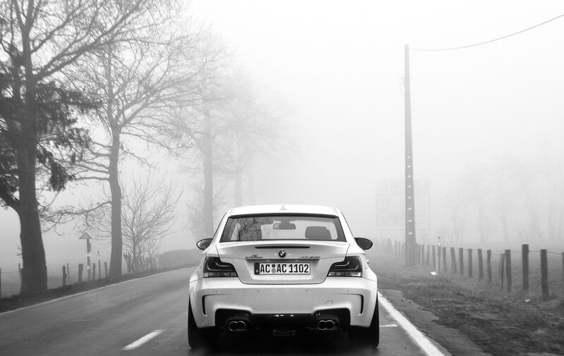 White car on foggy road