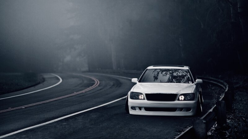 White car on foggy road