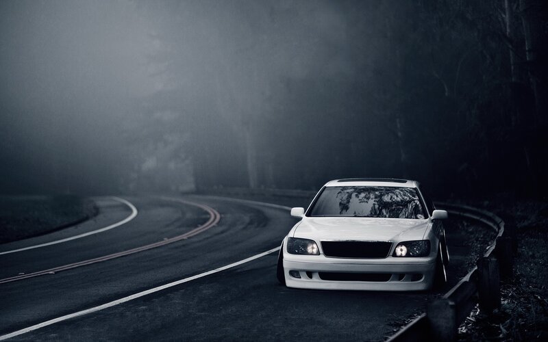 White car on foggy road