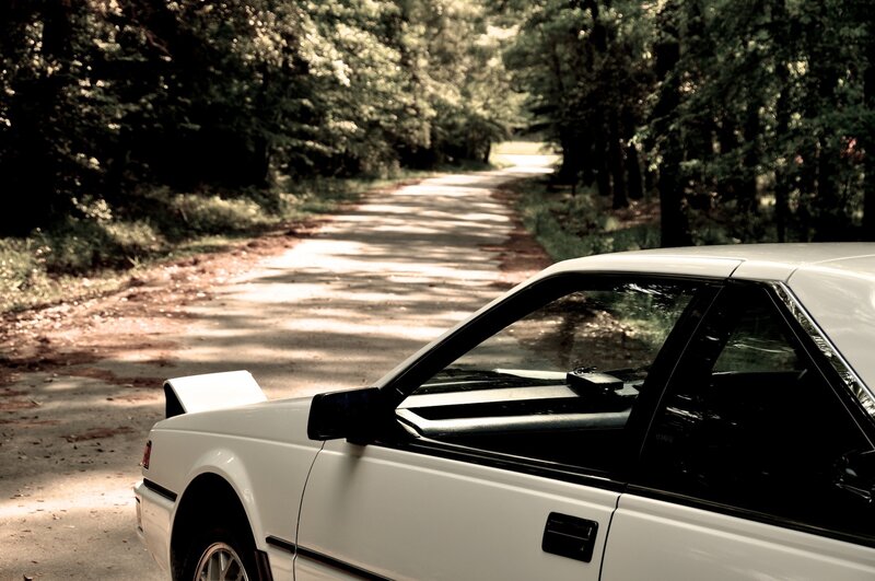 White Car on Forest Road — Serene