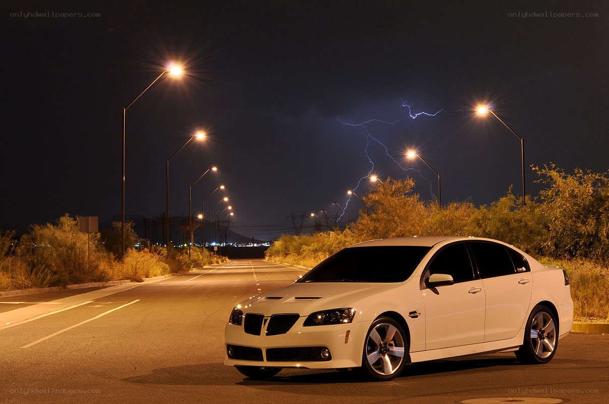 White car on road at night