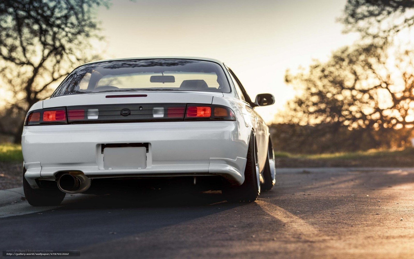 white car on road at sunset