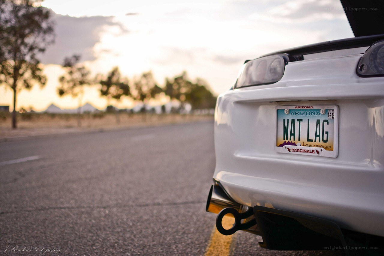 white car on road at sunset