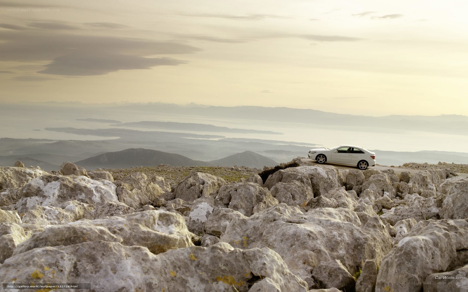 White car on rocky cliff