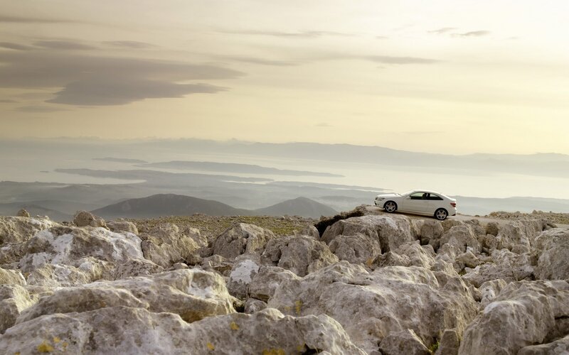 White car on rocky cliff