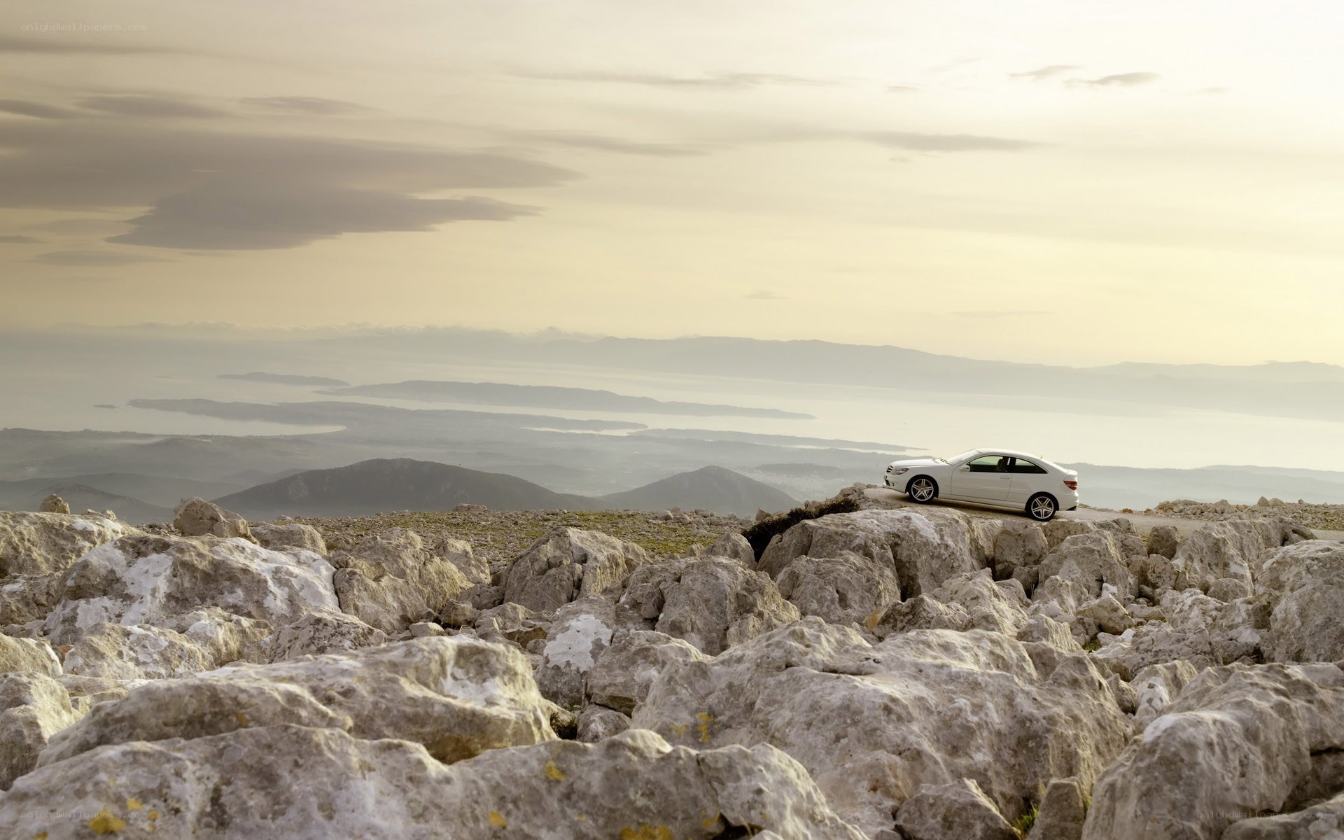 White car on rocky cliff