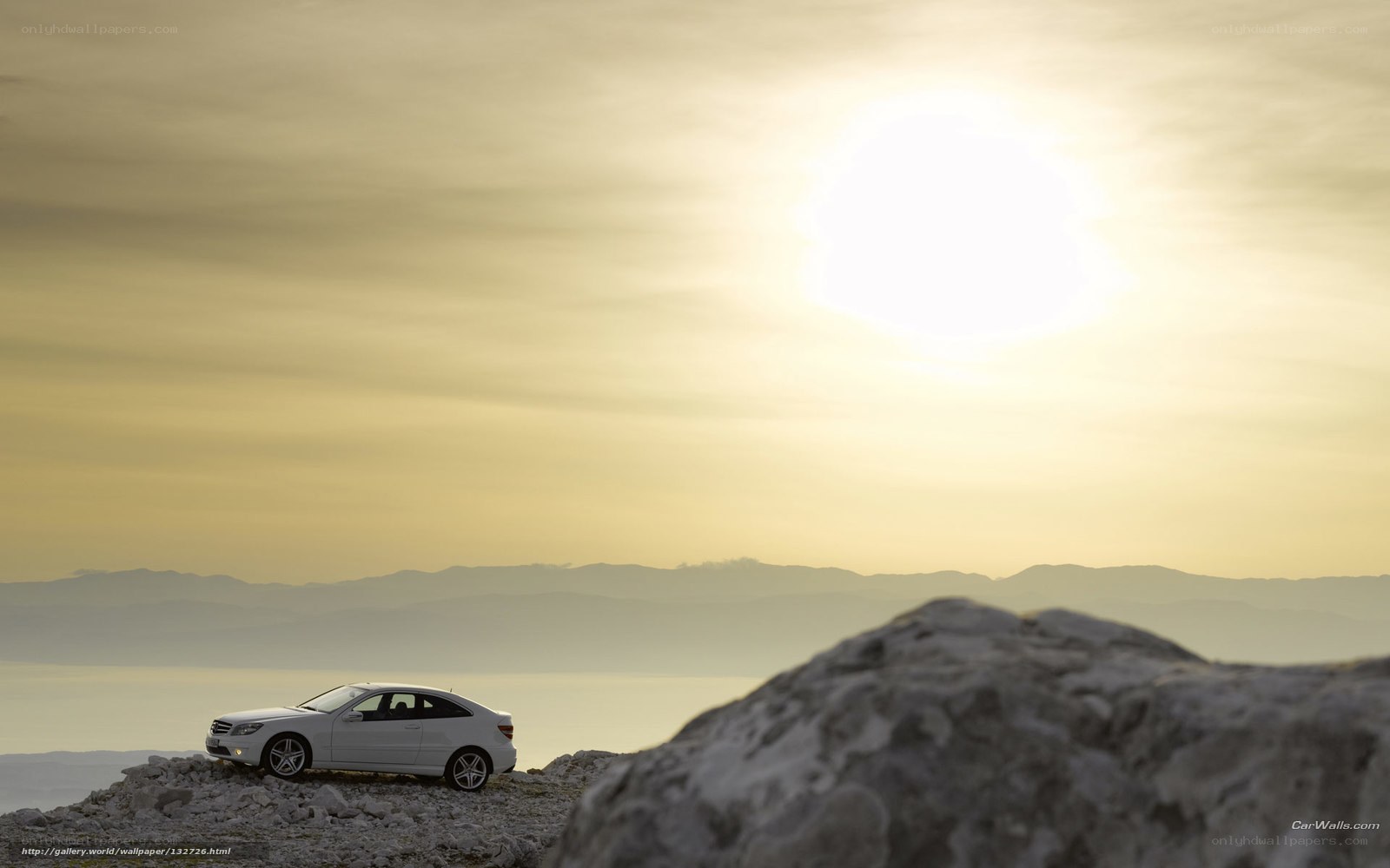 White car on rocky cliff