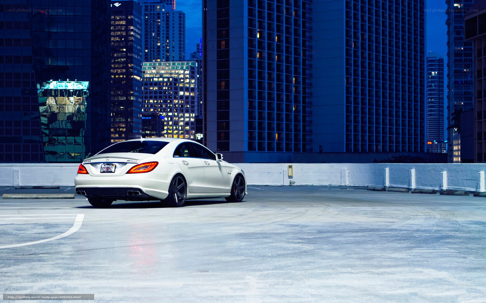 White car on rooftop at night