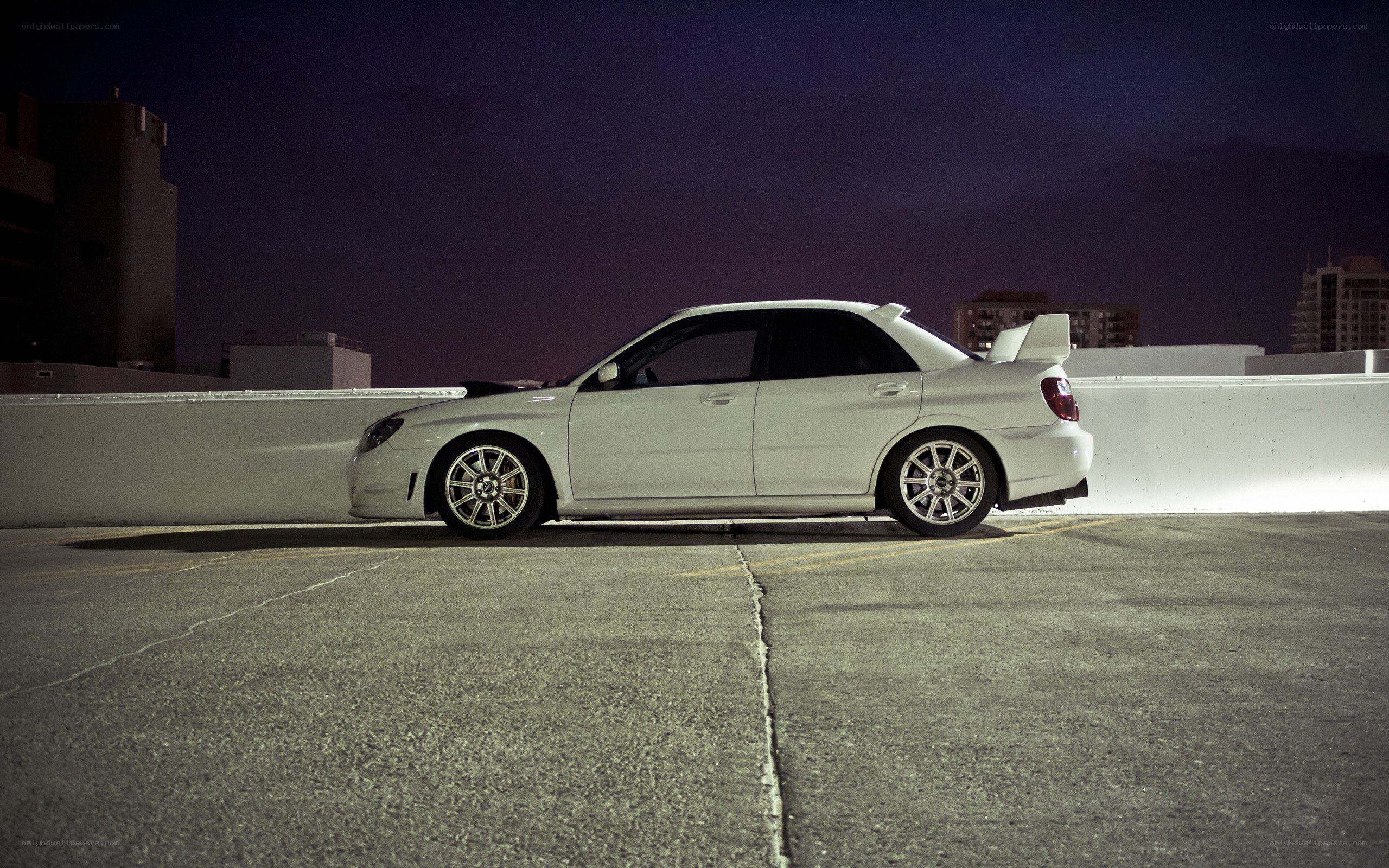white car on rooftop at night