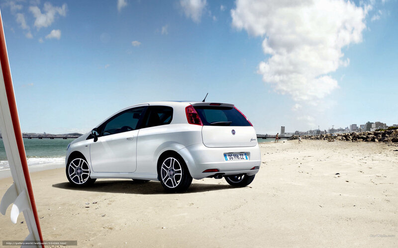 White car on sandy beach