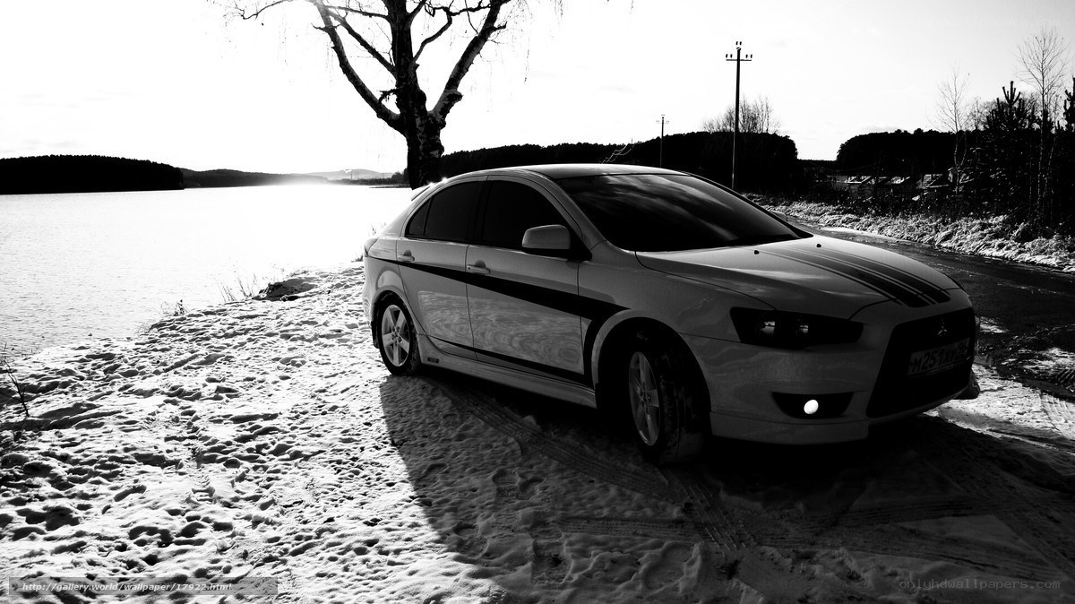 White car on snowy lake shore
