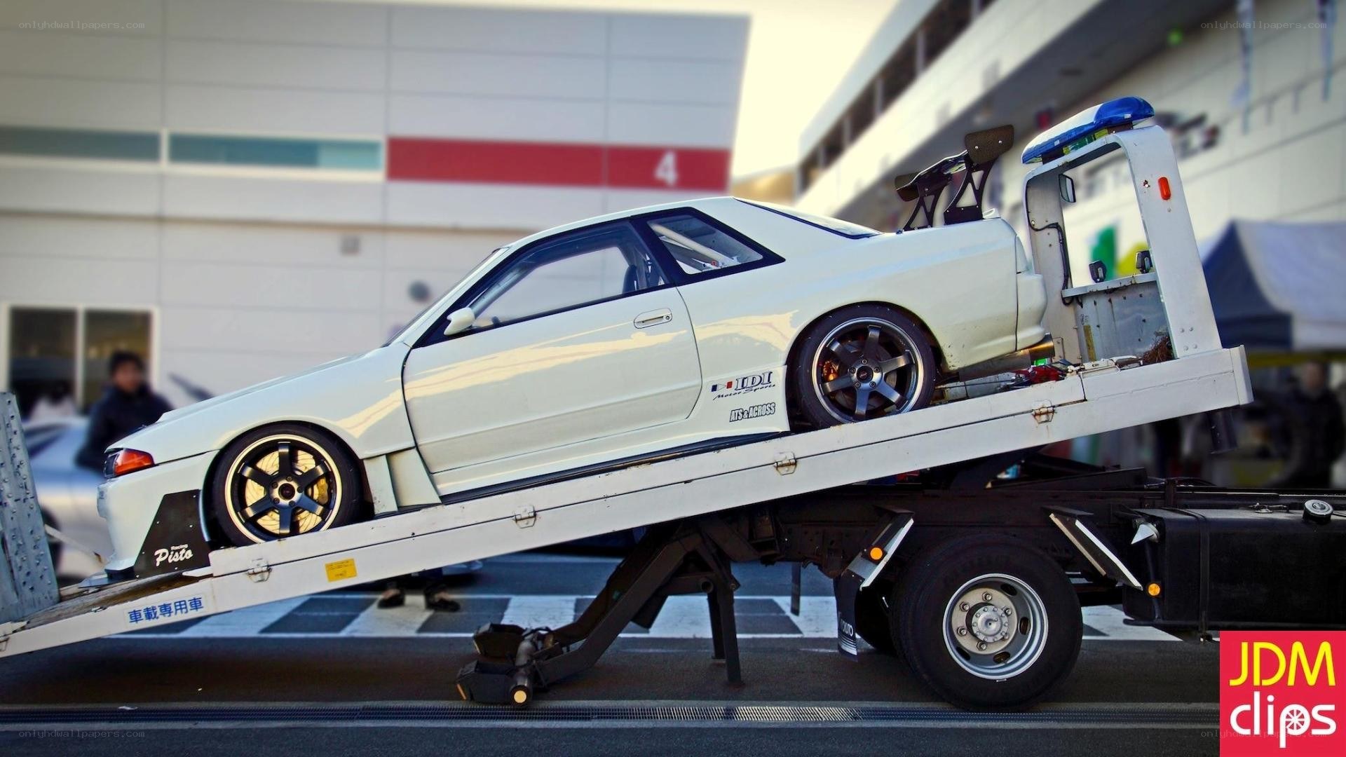 white car on tow truck