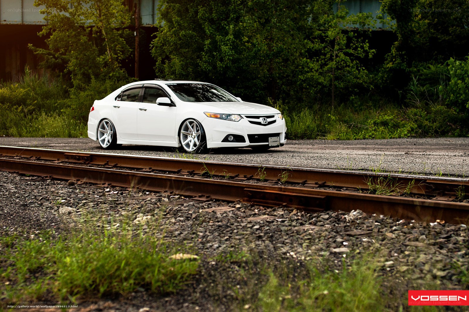 white car on train tracks