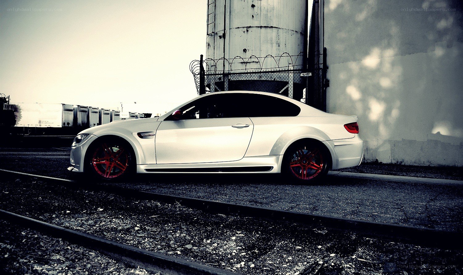 white car on train tracks
