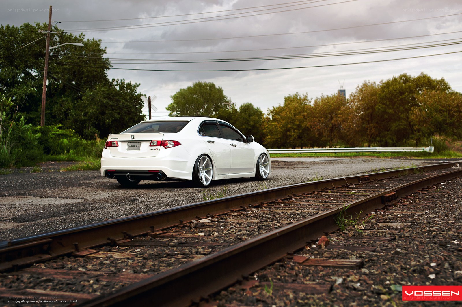 white car on train tracks