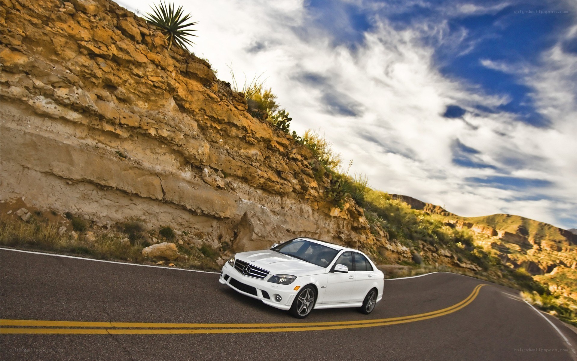 White car on winding road