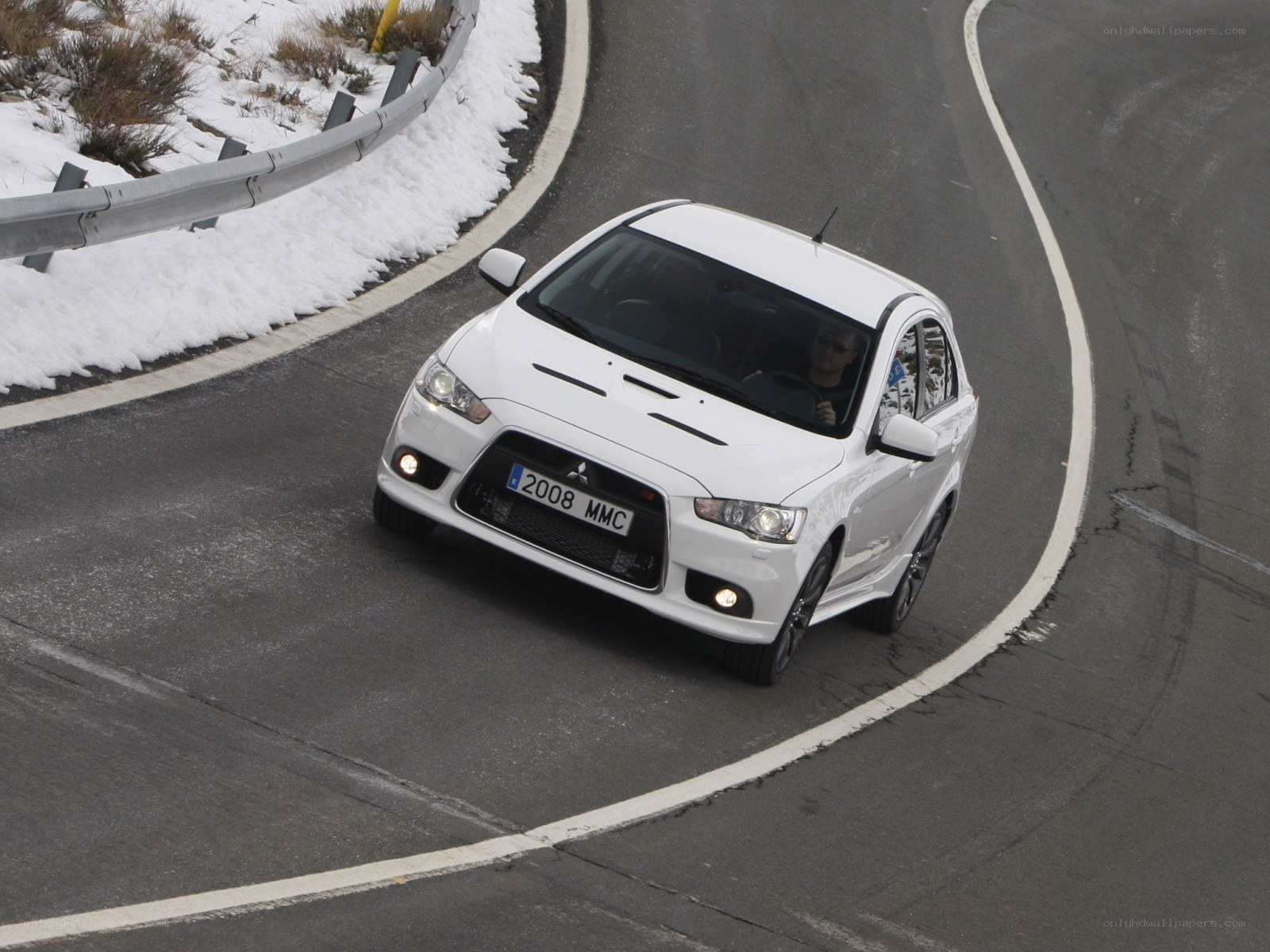 white car on winding road