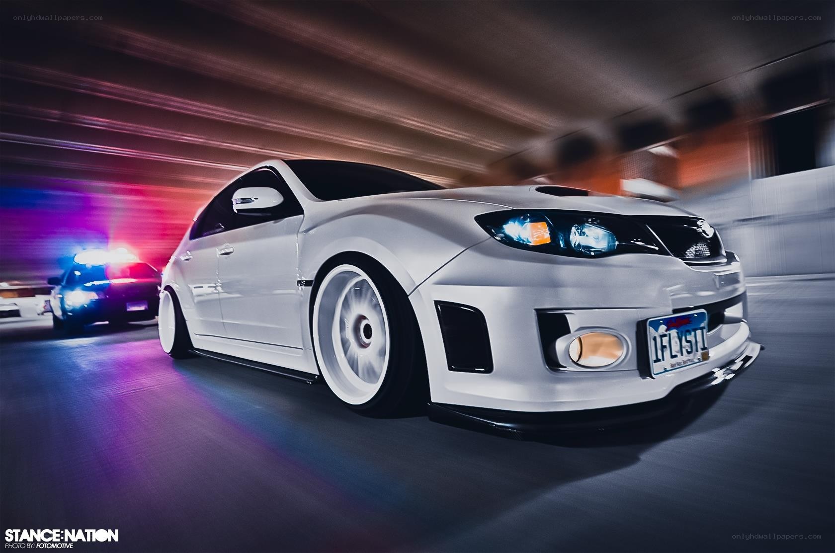 white car racing at night