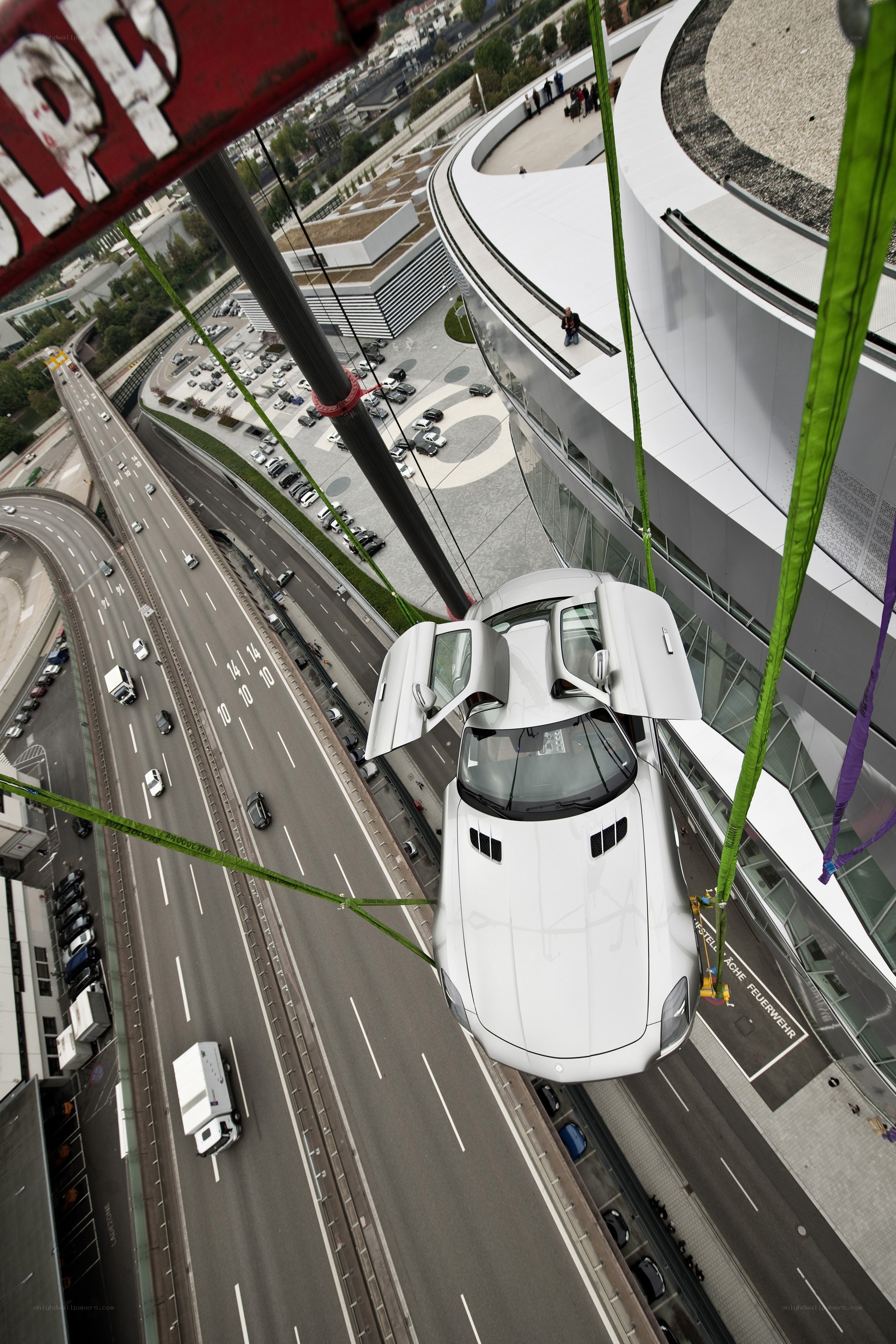White car suspended by crane