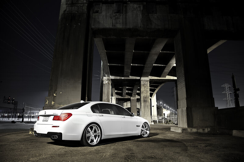 White car under a bridge at night