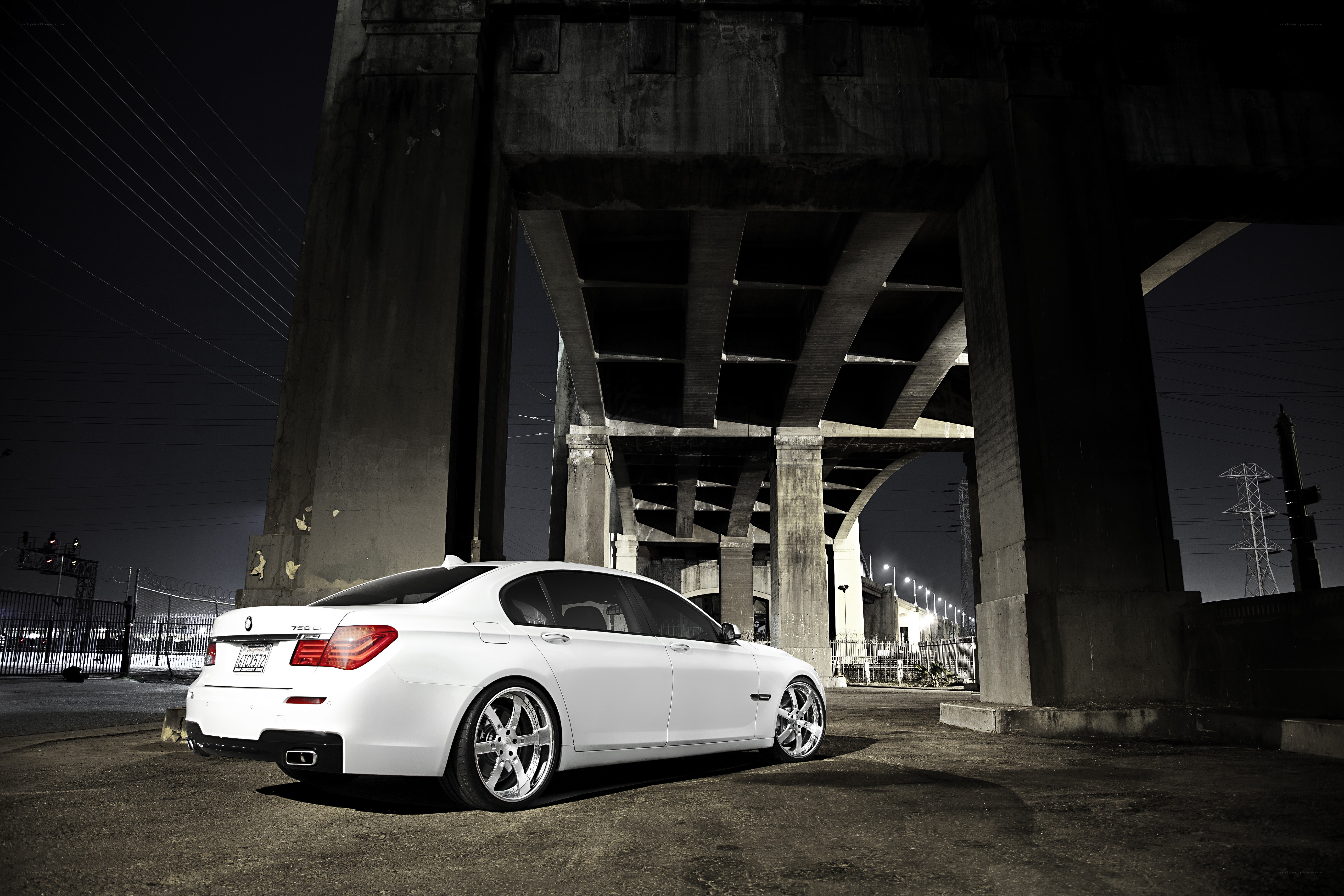 White car under a bridge at night