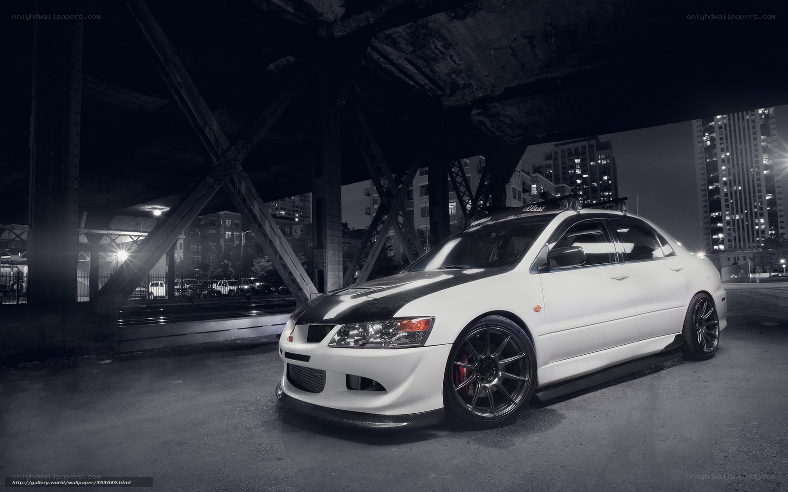 White car under bridge at night