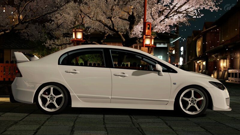 White car under cherry blossoms