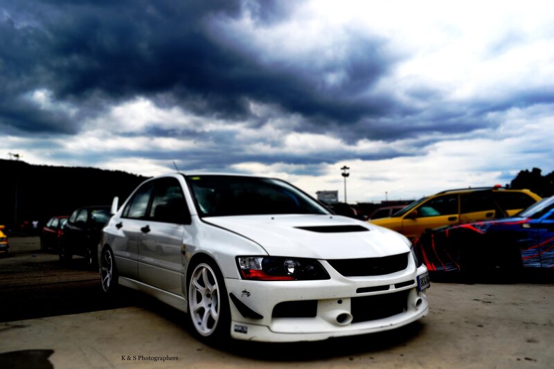 White car under stormy sky