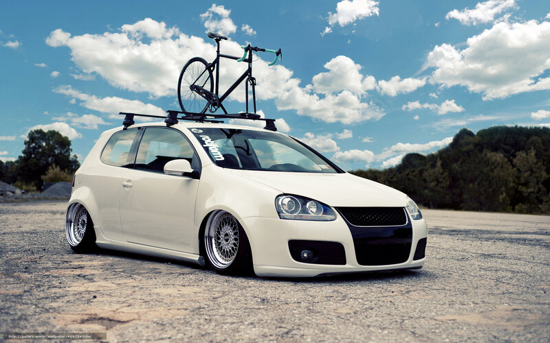 white car with bike on roof