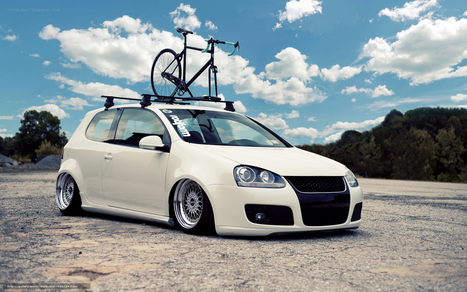 white car with bike on roof