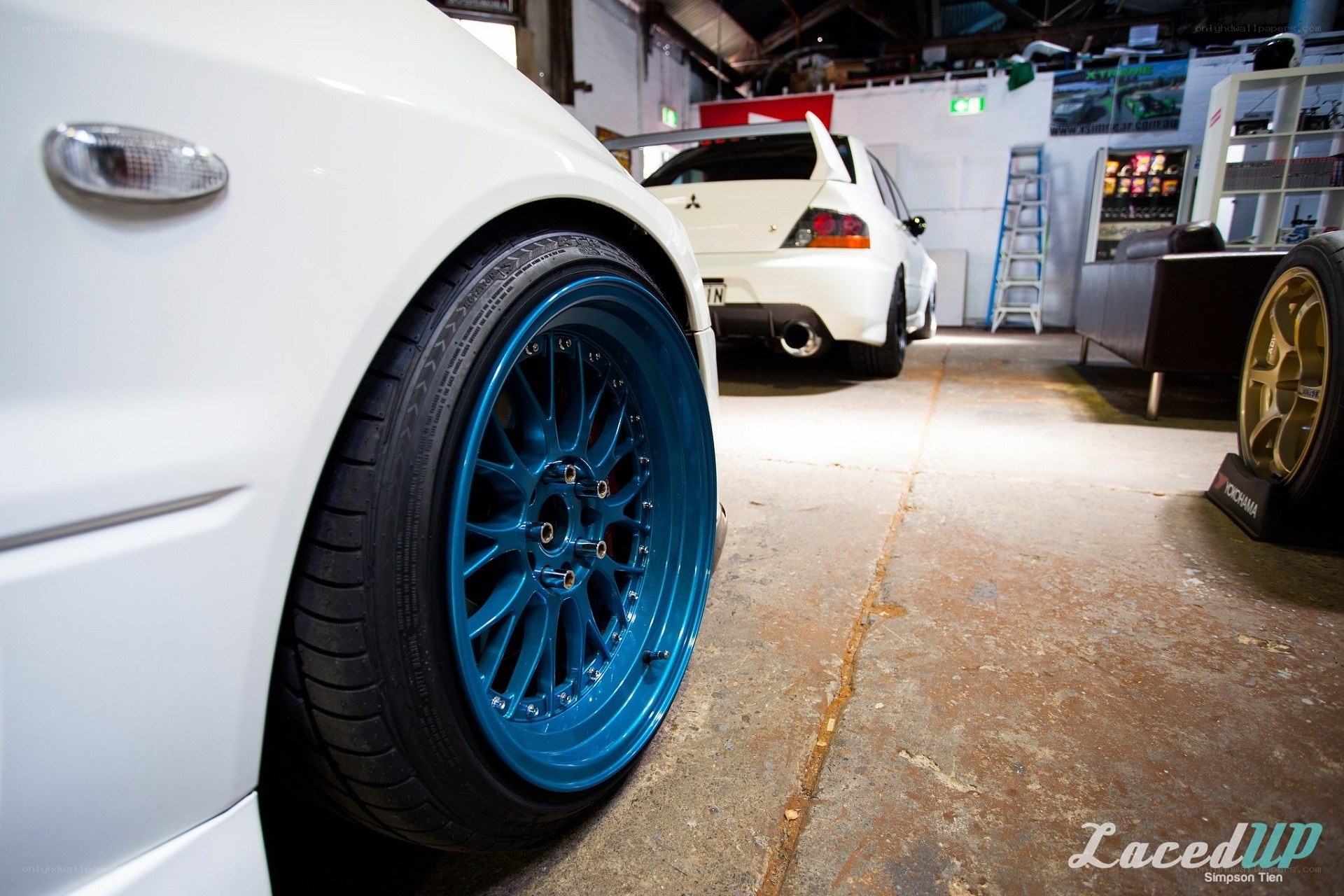 White car with blue wheels