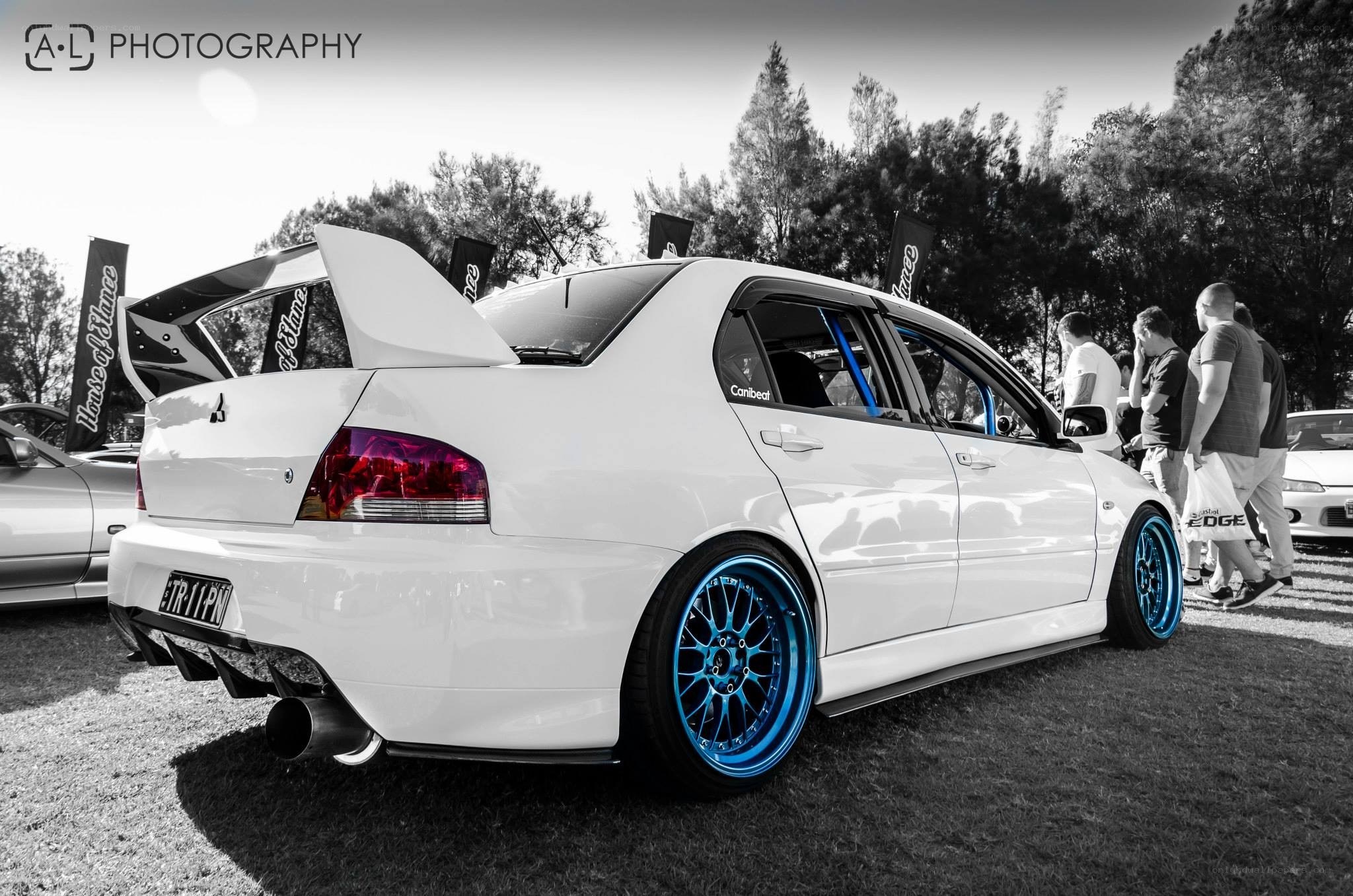 White car with blue wheels
