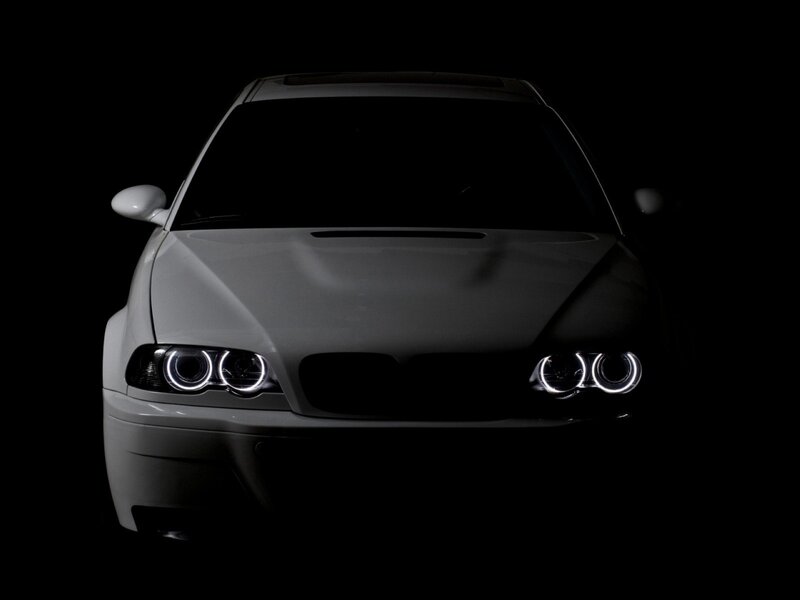 white car with illuminated headlights
