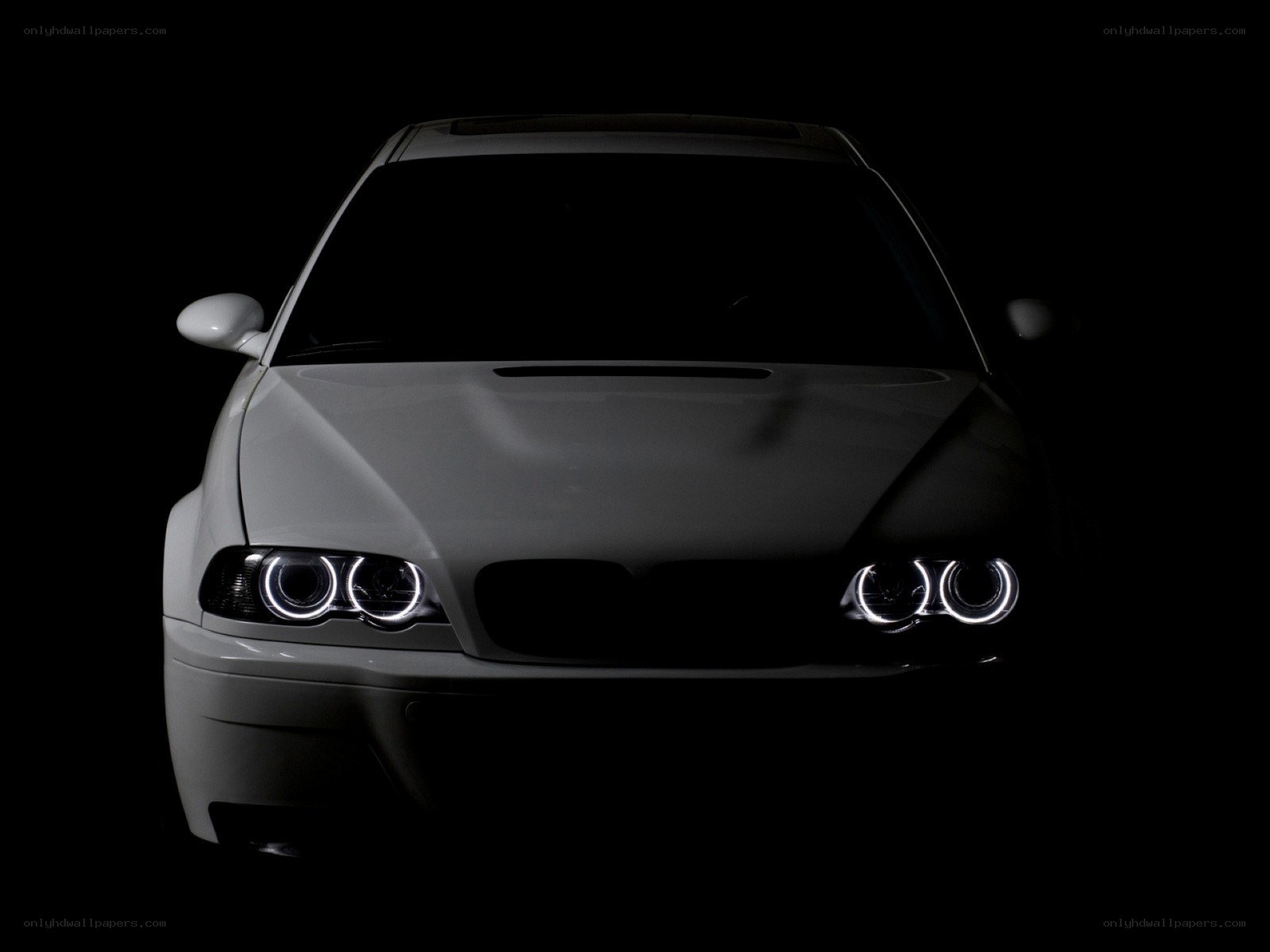white car with illuminated headlights