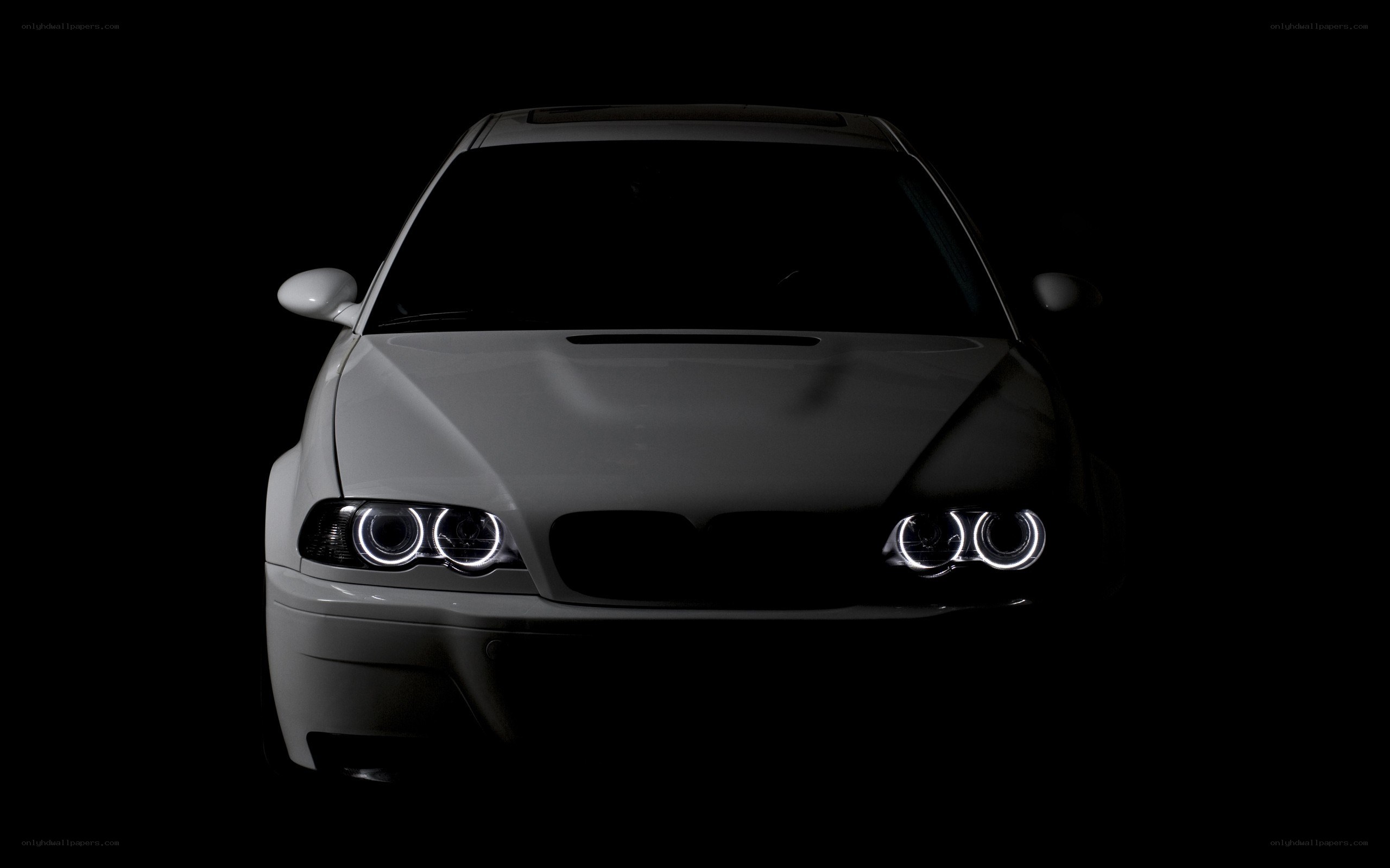 white car with illuminated headlights