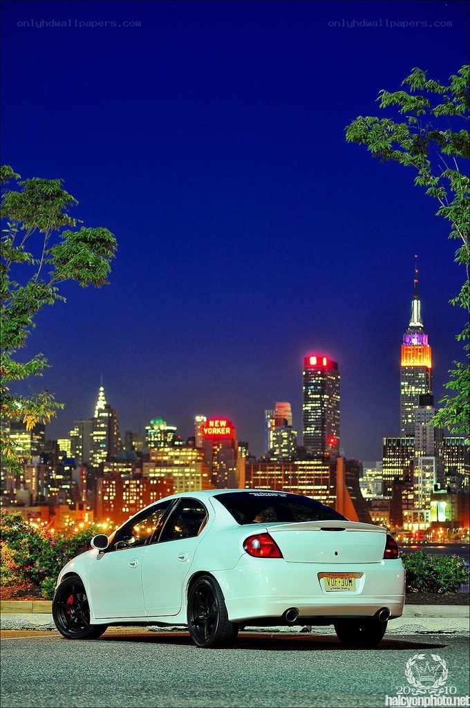 White car with NYC skyline