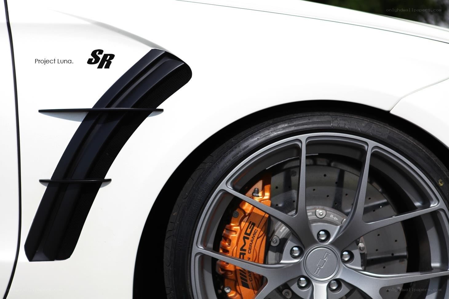 White car with orange brakes