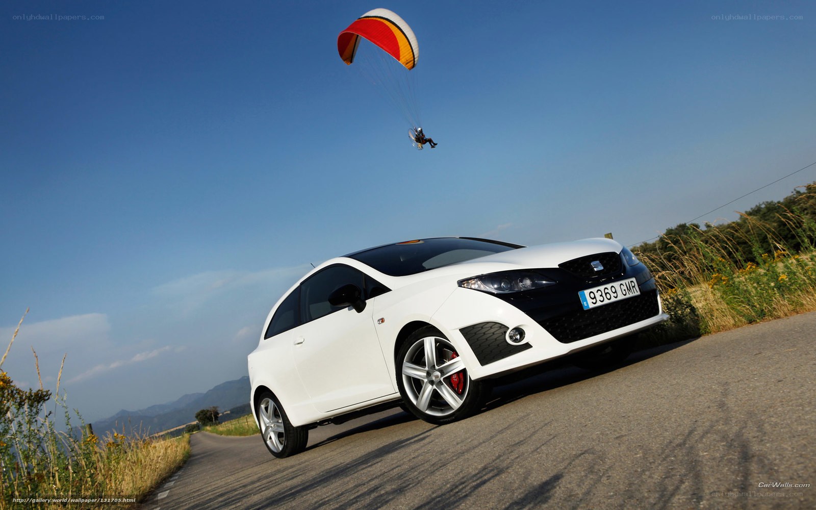 White car with paraglider