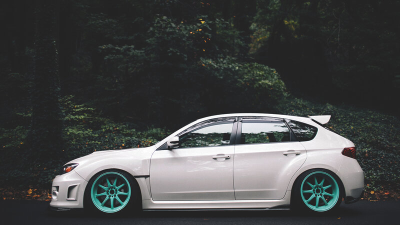 white car with teal wheels