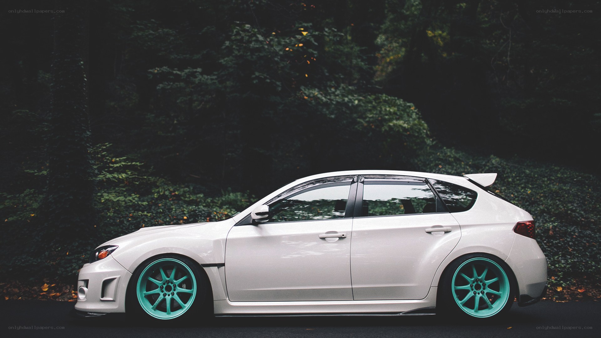 white car with teal wheels