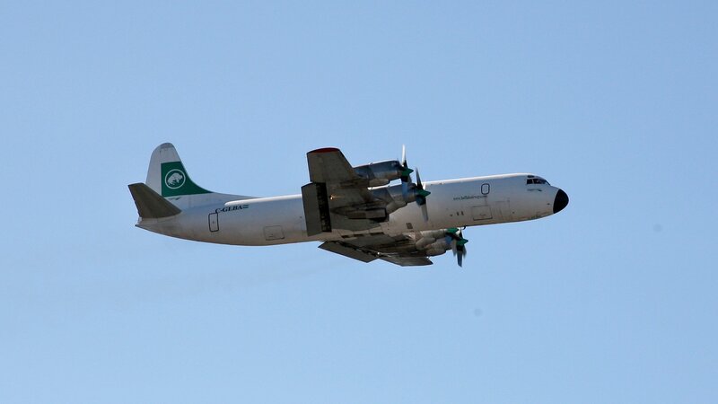 white cargo plane in flight