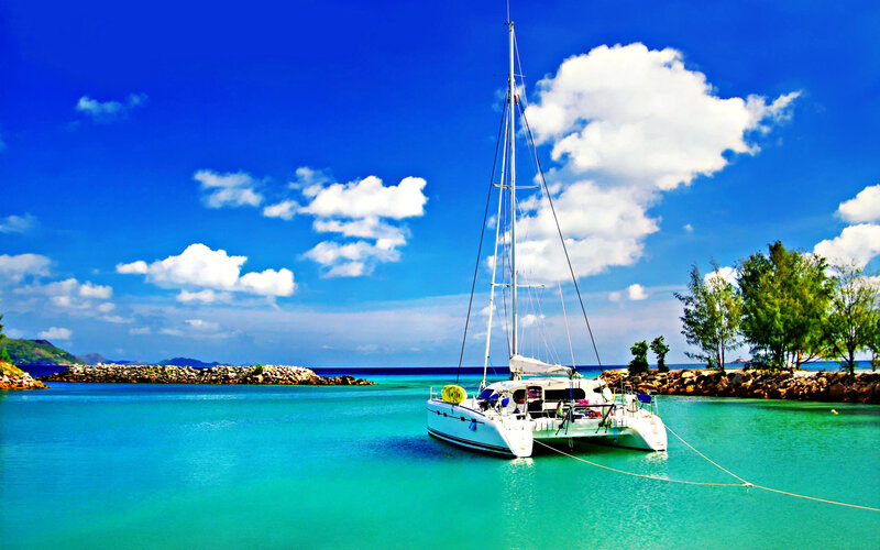 White Catamaran in Bay — Blue