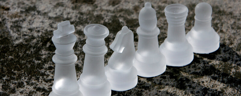 white chess pieces on stone