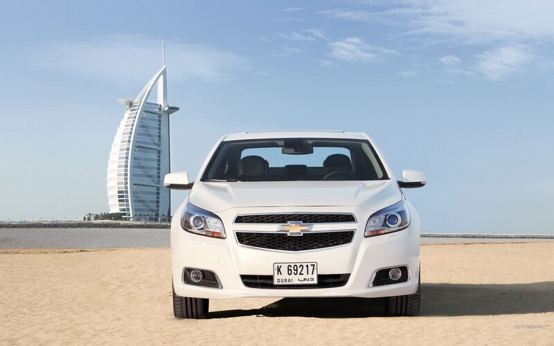 White Chevrolet Malibu on beach
