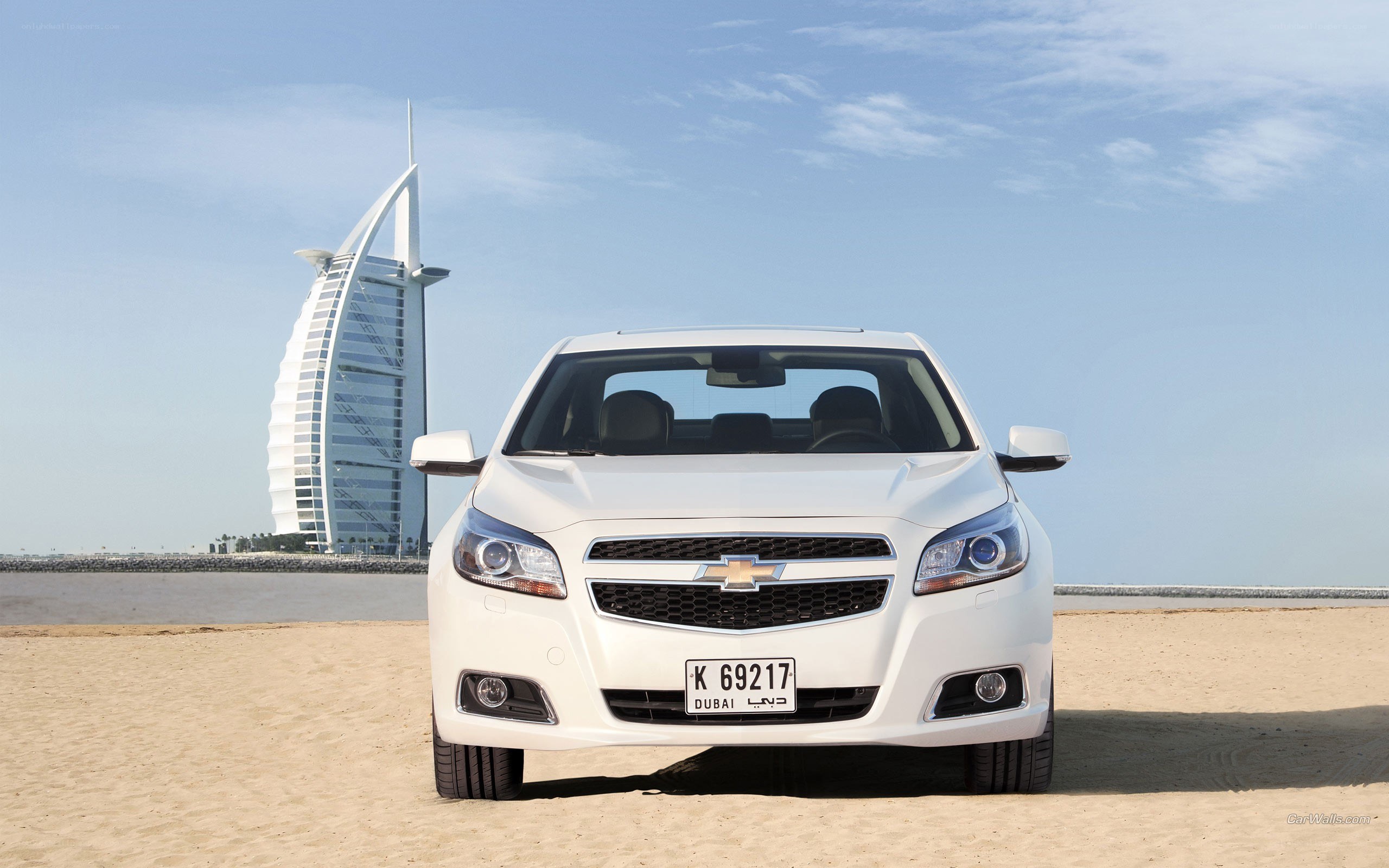 White Chevrolet Malibu on beach
