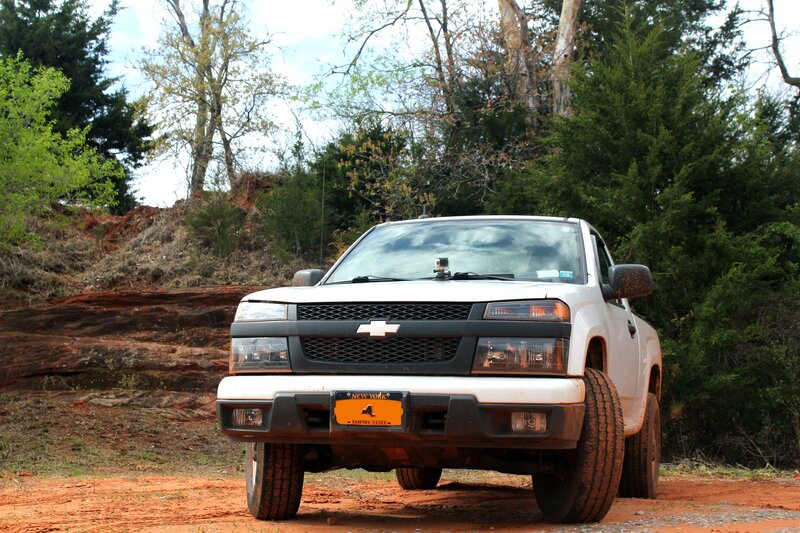 White Chevrolet truck on dirt road