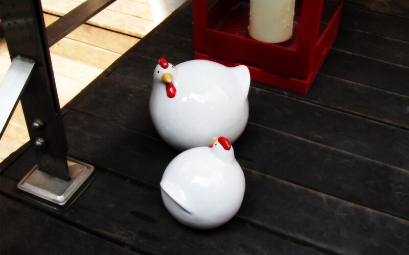 White chicken figurines on deck