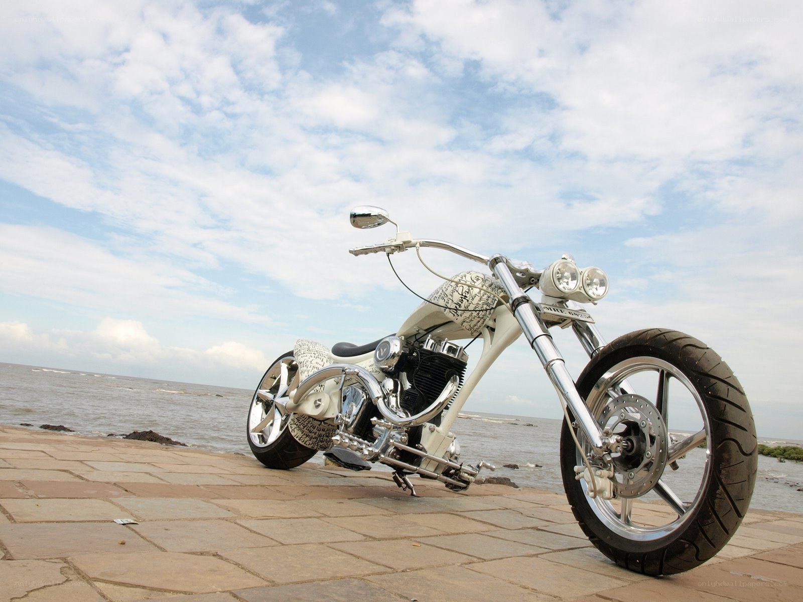 White chopper motorcycle by the sea